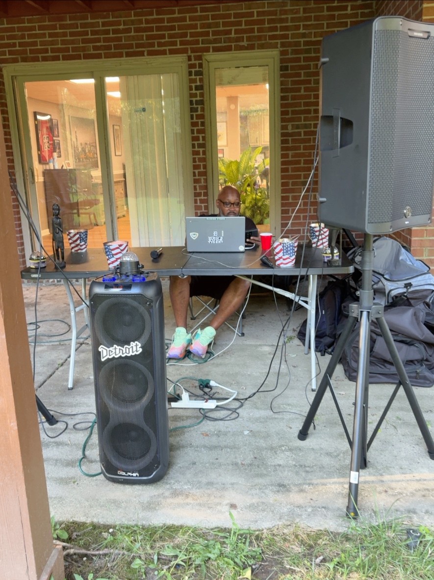 DJ Metaphoric with his laptop, speakers, microphones and event equipment